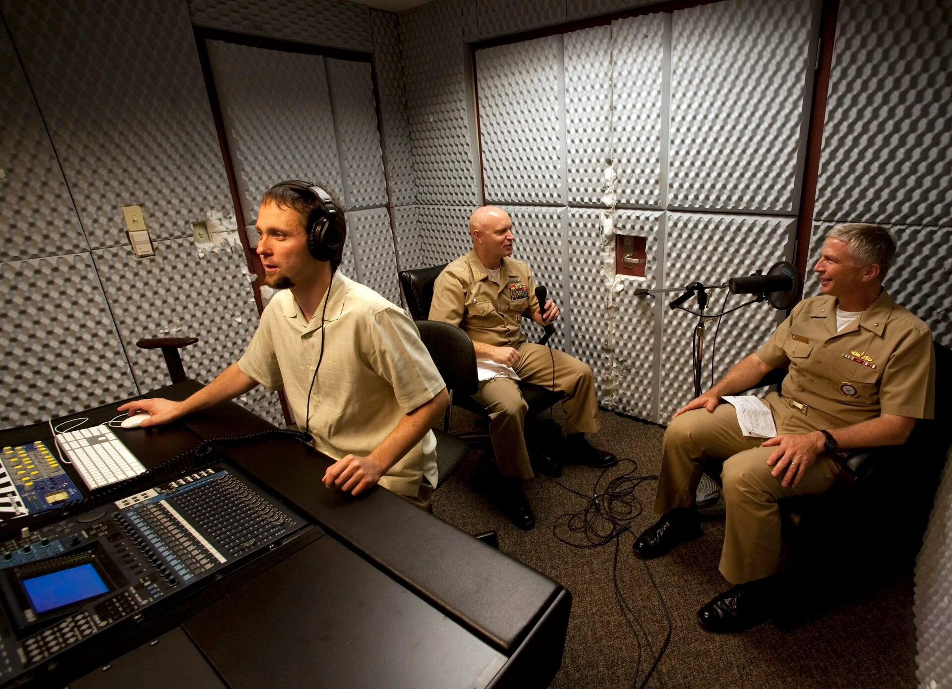 GREAT LAKES, Ill. (May 14, 2010) Rear Adm. Craig Faller, right, commander of Navy Recruiting Command (NRC) and Senior Chief Mass Communication Specialist Tom Jones conduct sound checks as Rafal Dziedziniewicz adjusts the recording levels before beginning a podcast. The NRC podcasts are posted on Fac