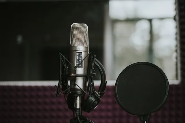Close-up of a microphone with pop filter in a modern music studio environment. How to build a podcast SEO outlook that survives platform change